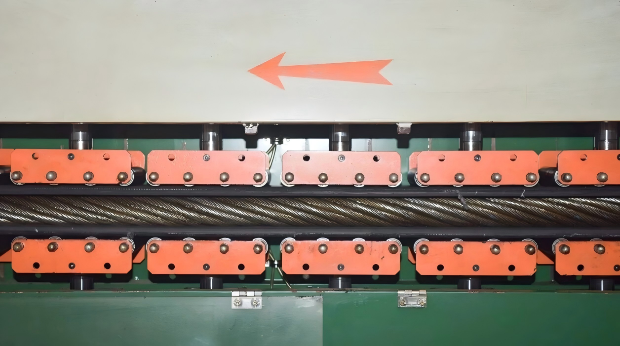 Large wire rope passing through industrial handling equipment