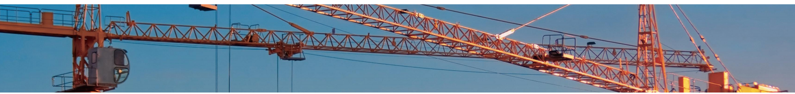 Tower cranes on a construction site using steel wire rope hoist lines