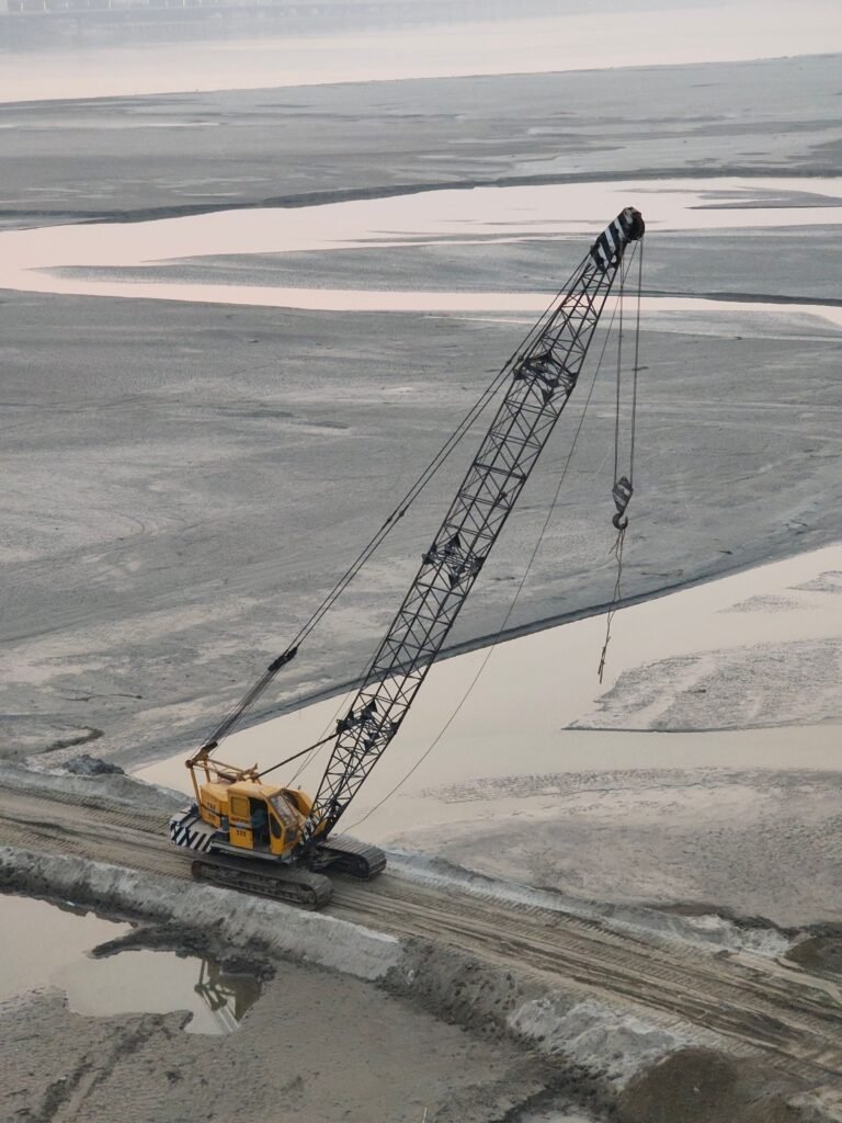 Large industrial crane at an active construction and excavation site