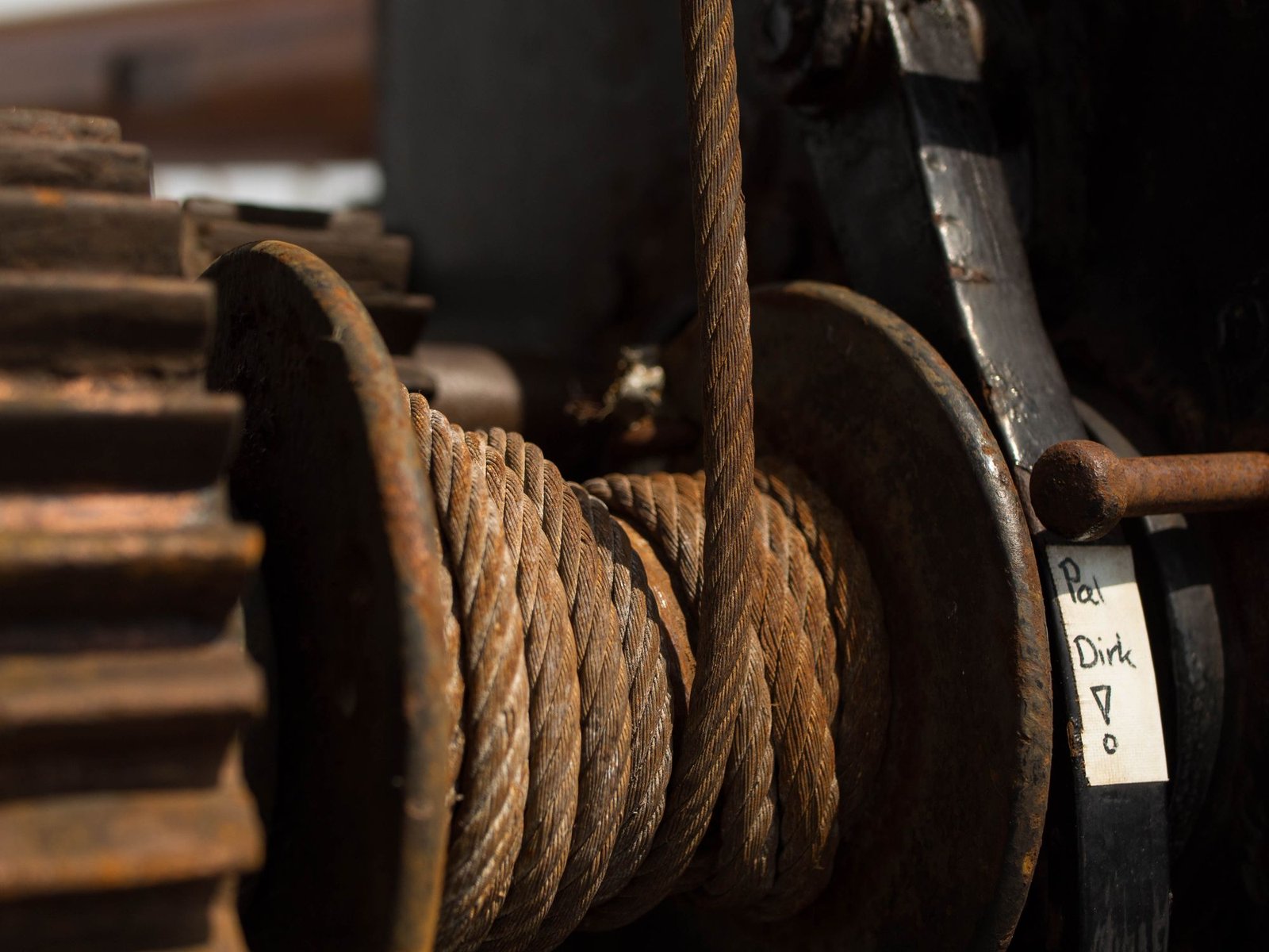 Weathered steel wire rope wound around an industrial roller